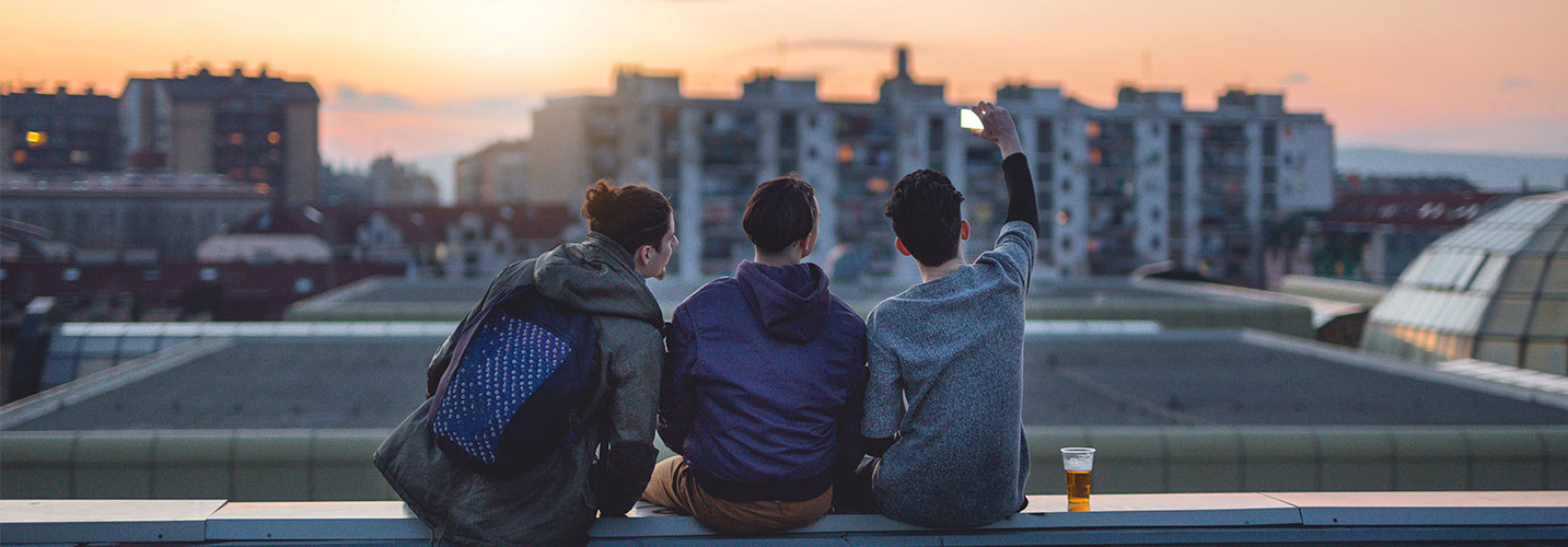 Three friends taking a selfie on a smartphone