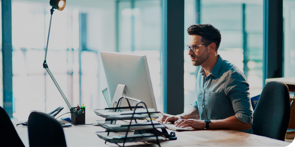 man working at a computer in an office